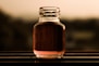 clear glass jar with brown liquid