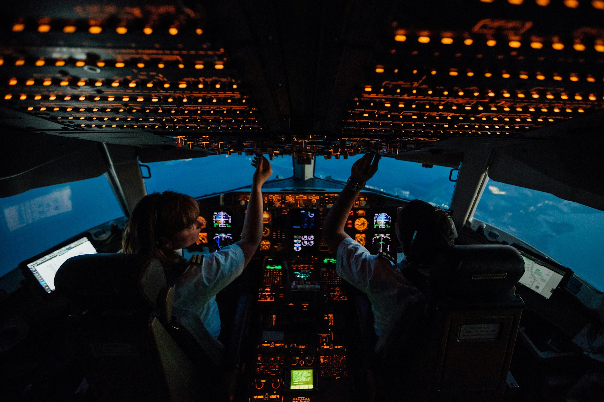 woman in white shirt sitting on airplane seat