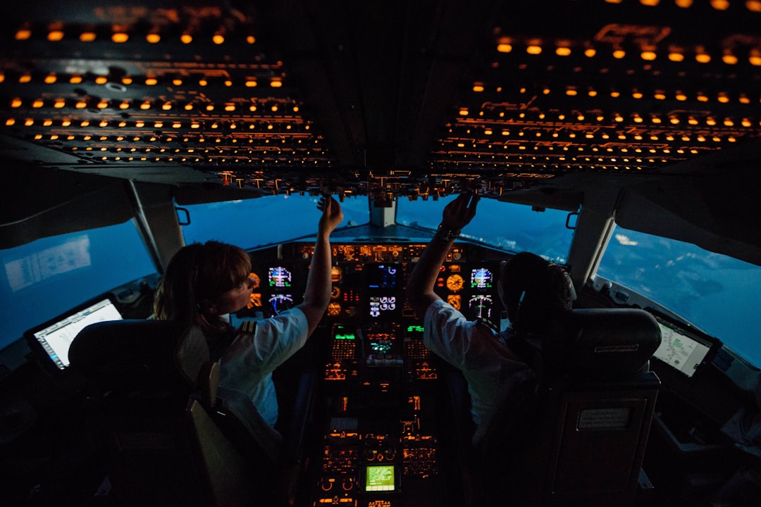 woman in white shirt sitting on airplane seat,