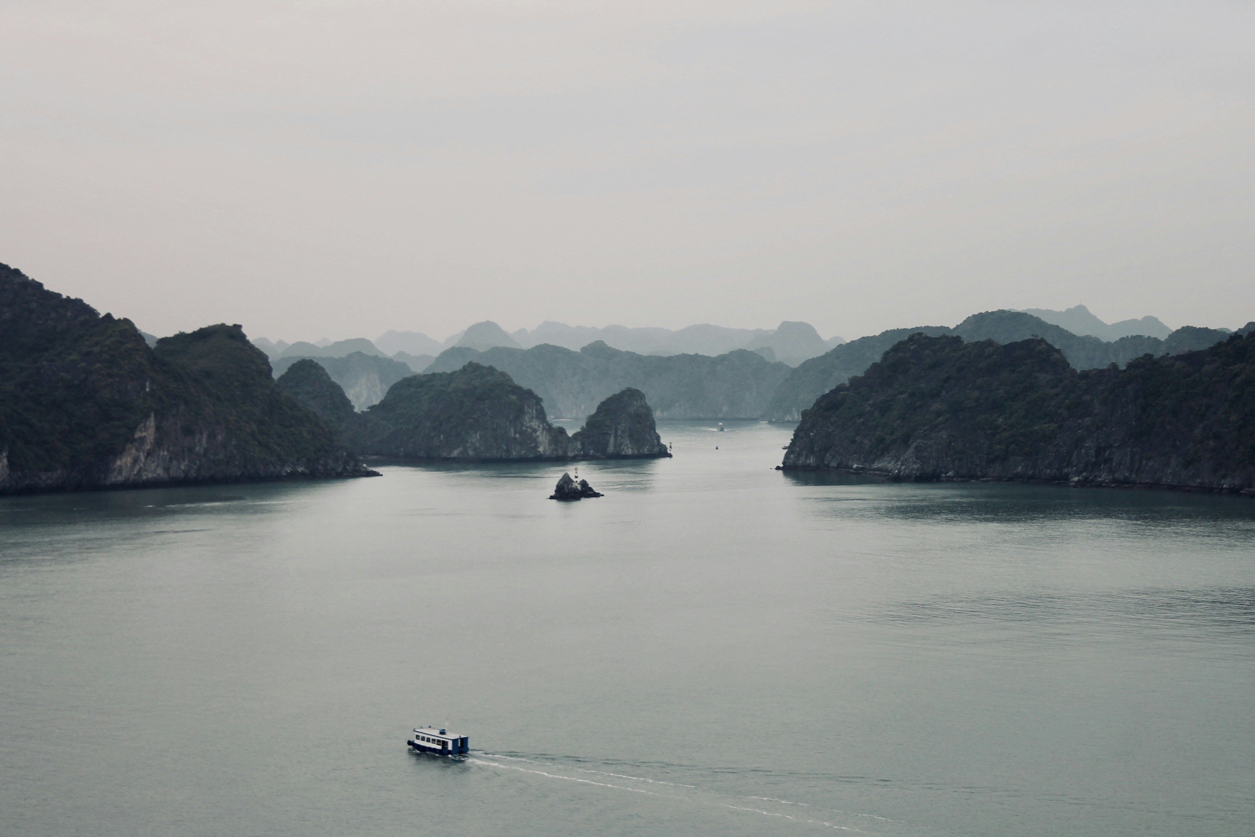 boat on sea near mountain during daytime, 