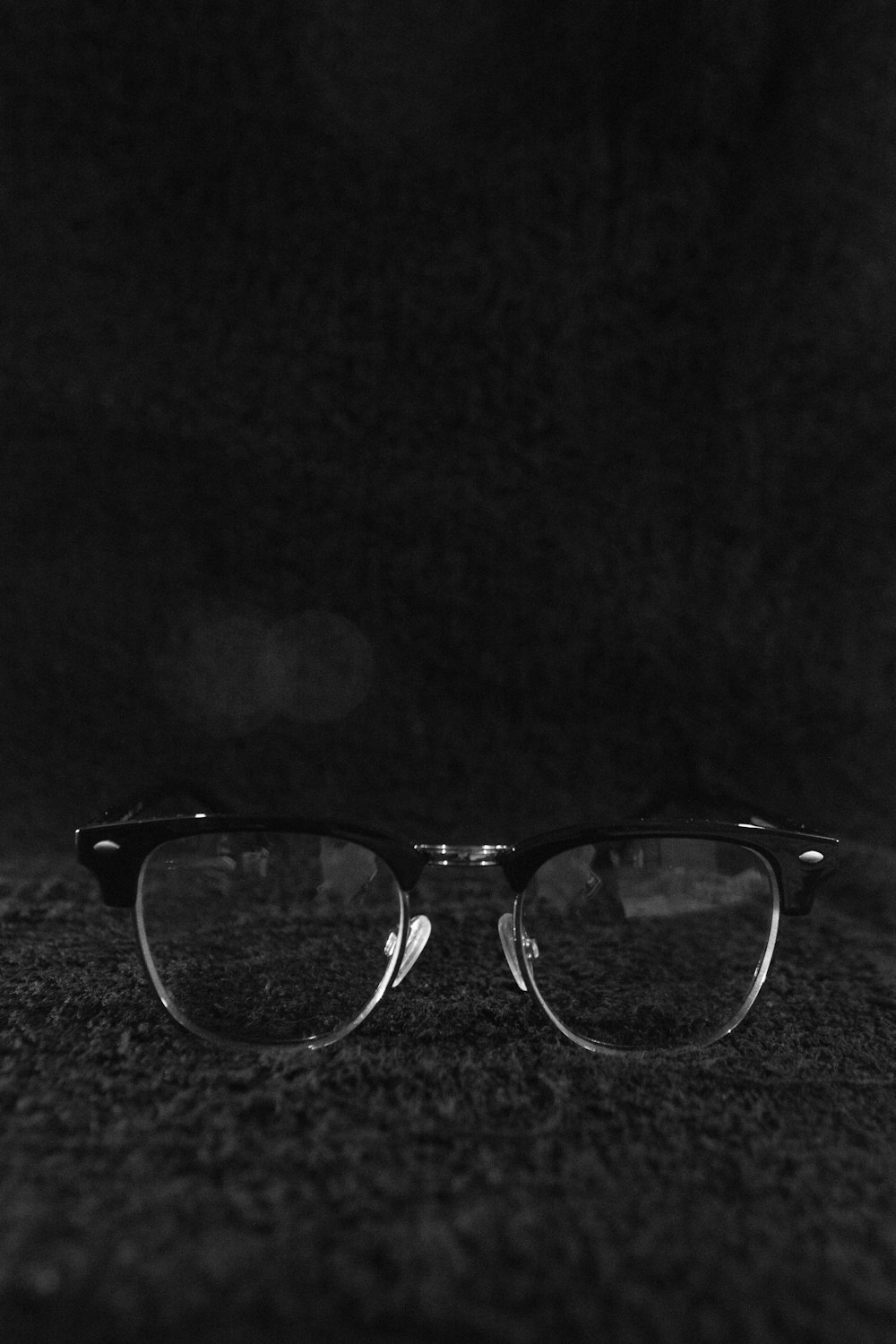 black framed eyeglasses on black textile
