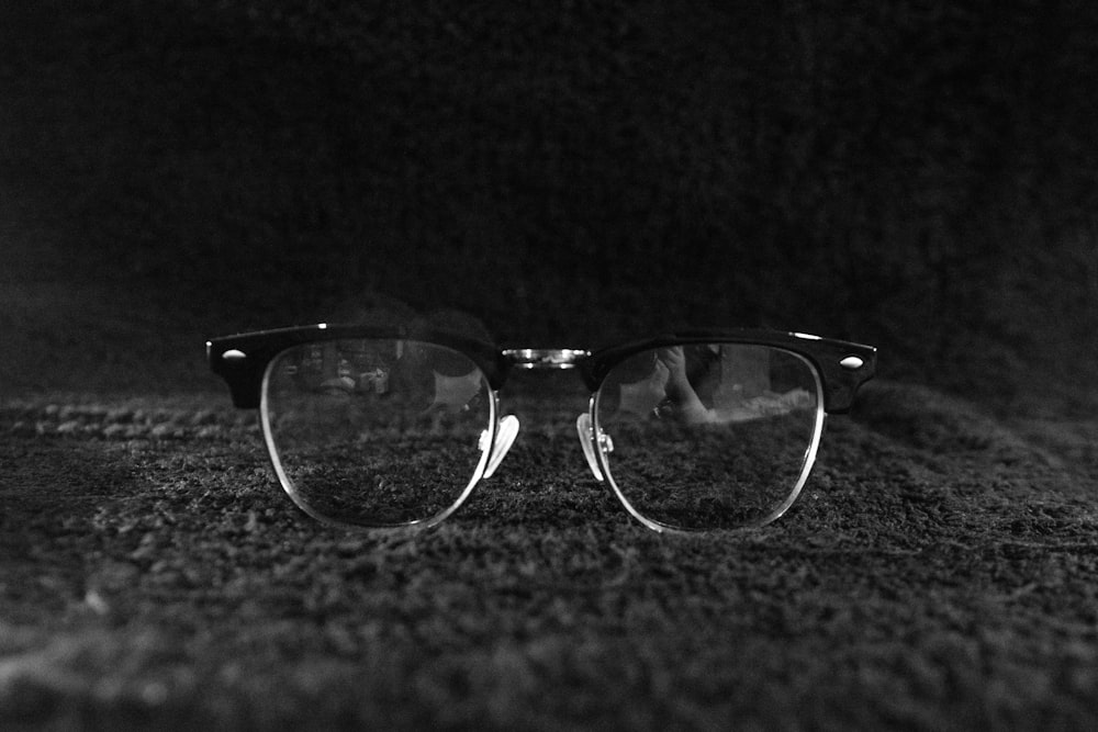 black framed eyeglasses on black textile