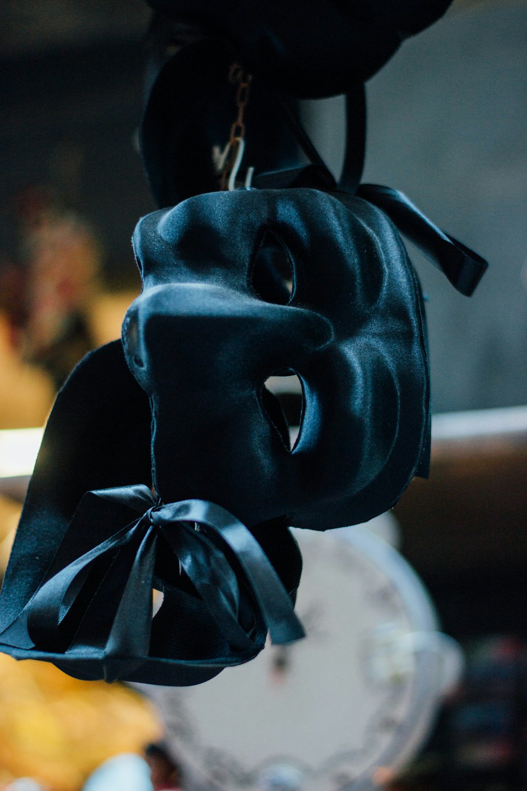black mask with blue ribbon