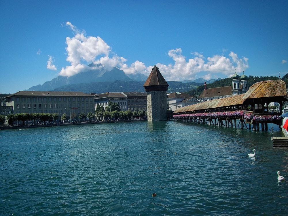 a body of water with a clock tower in the middle of it