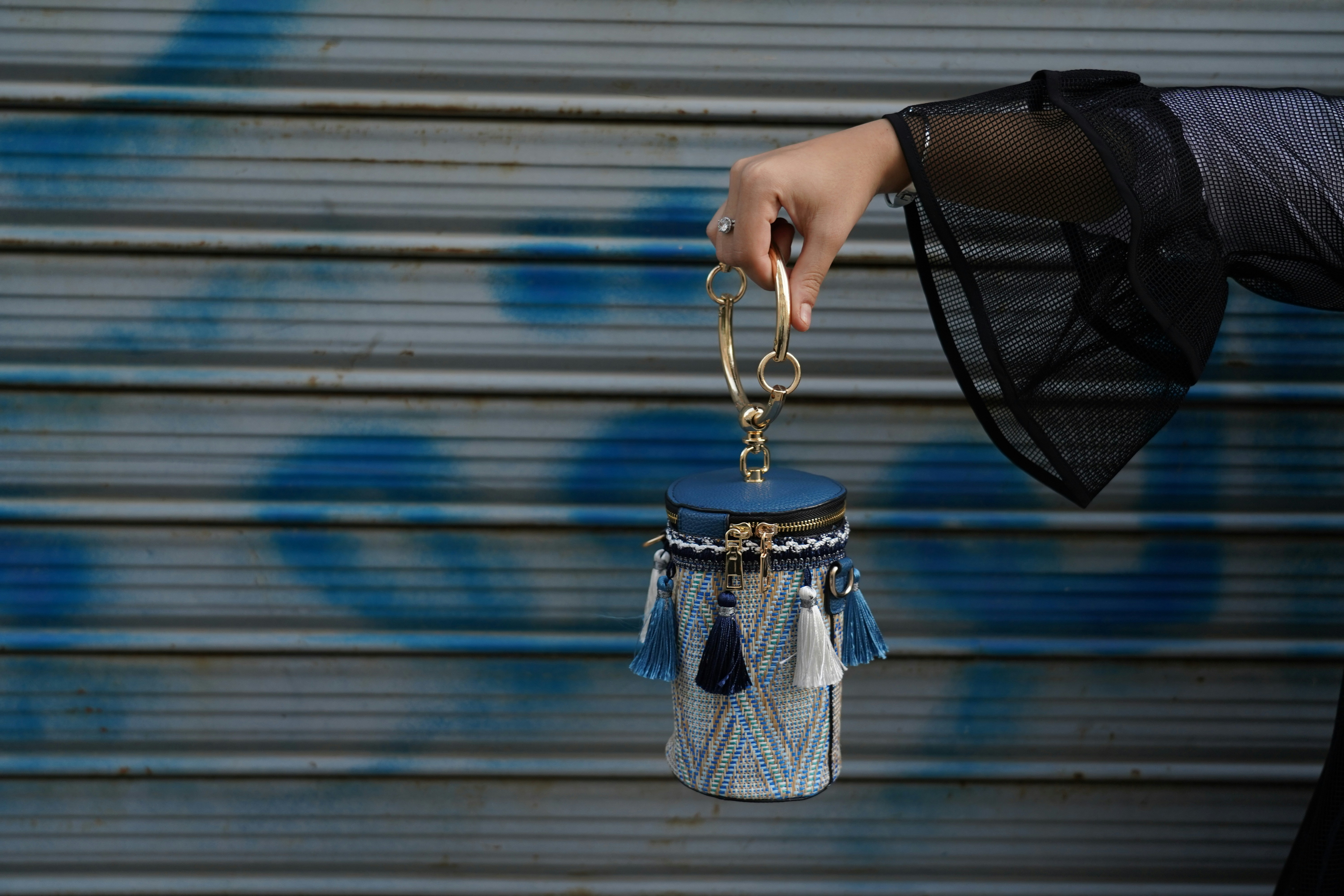 person holding silver and black hanging decor