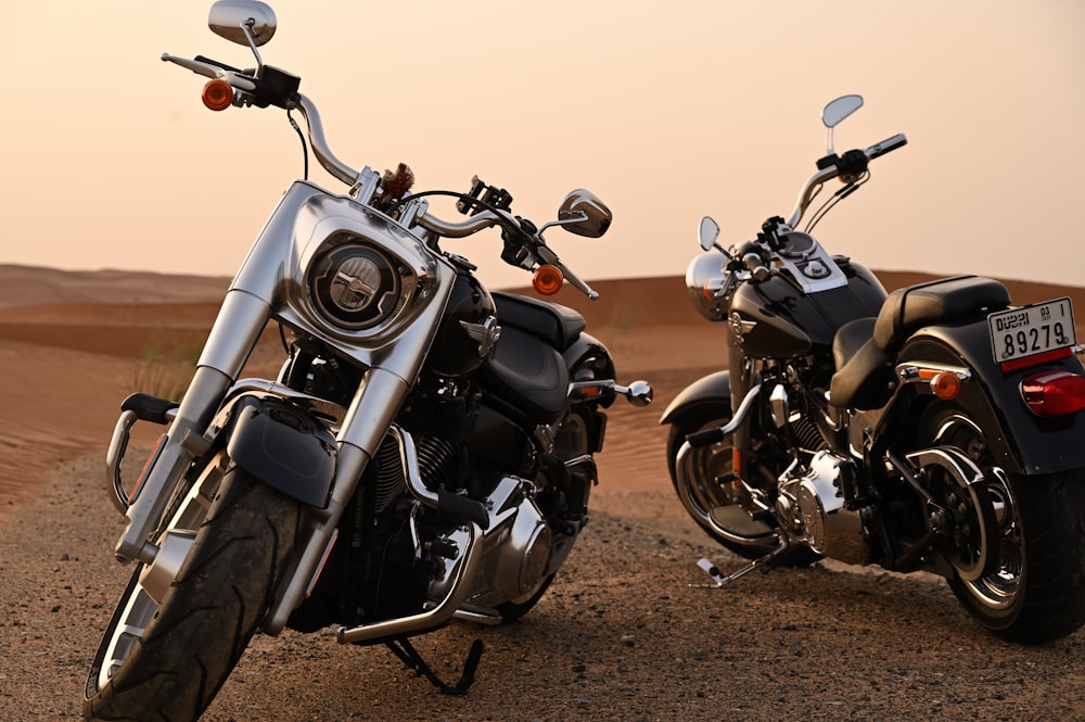 black and silver motorcycle on brown sand during sunset