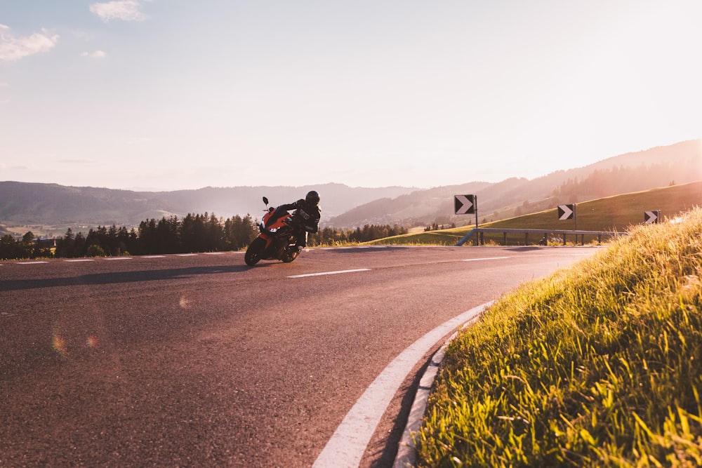 man in black jacket riding motorcycle on road during daytime