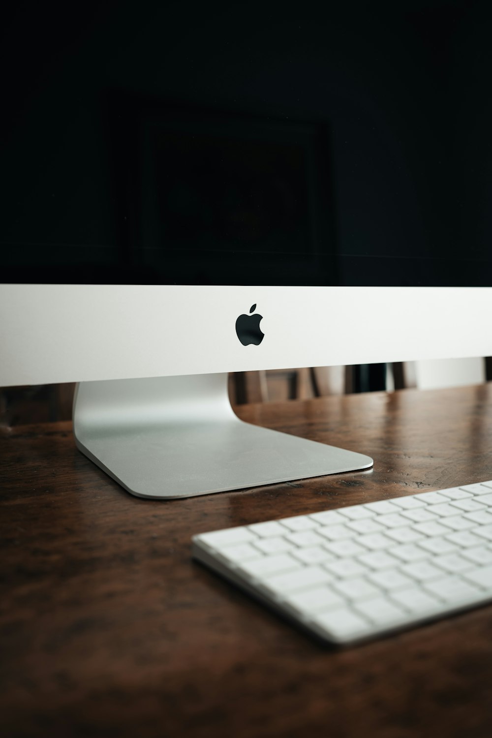 silver imac on brown wooden table