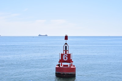 red and white ship on sea during daytime