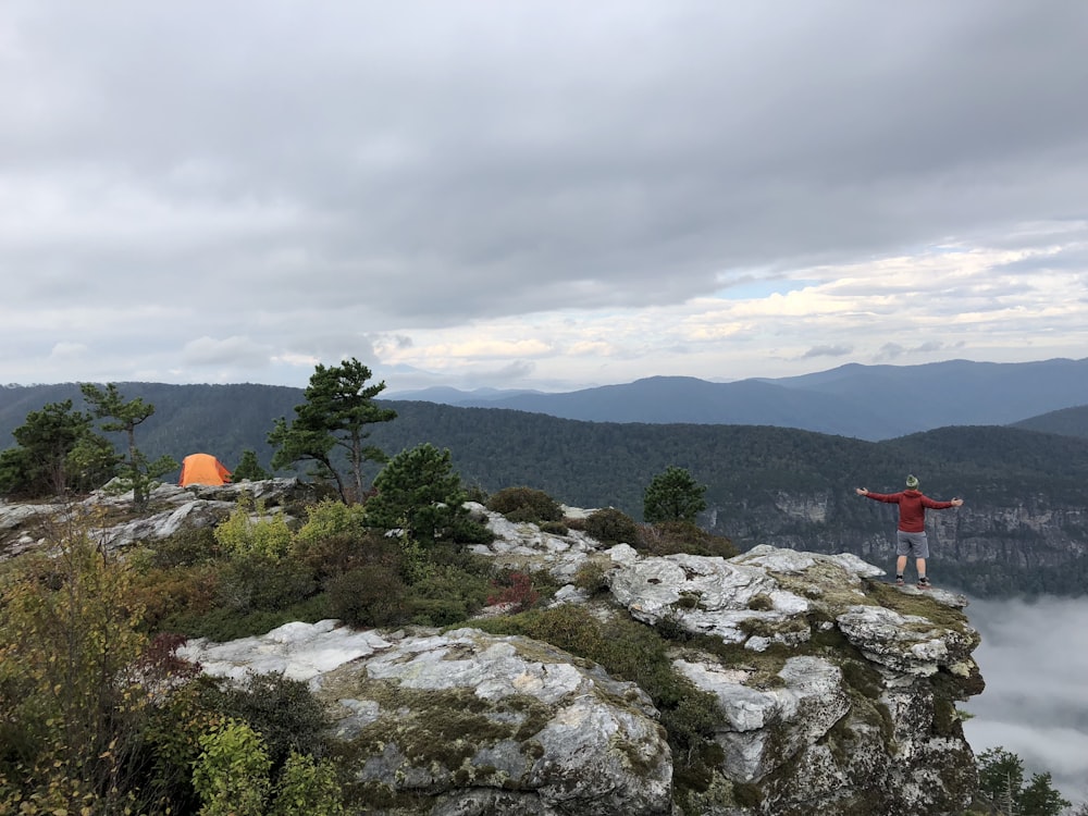 green trees on mountain under cloudy sky during daytime