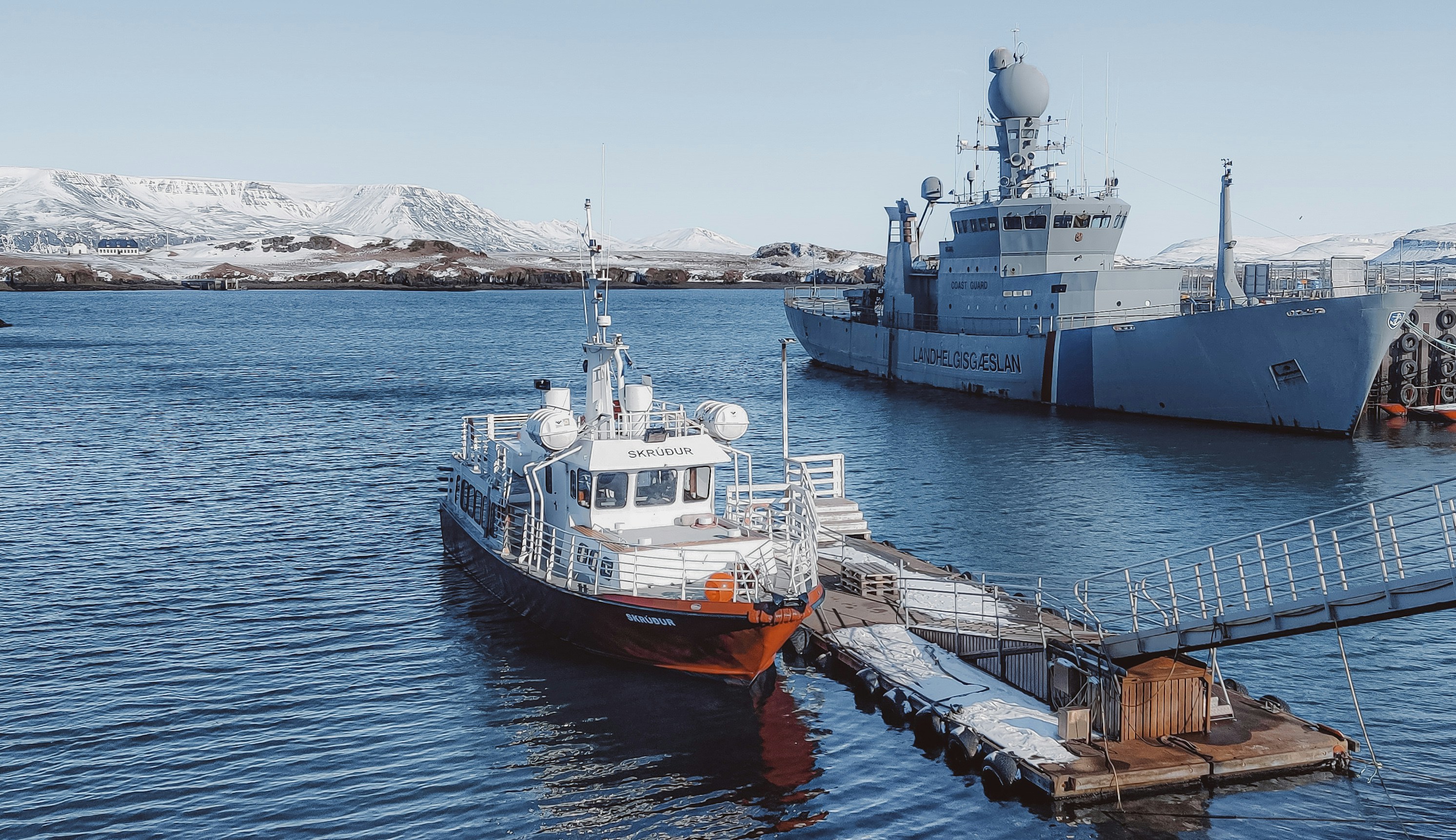 a large boat is docked at a pier