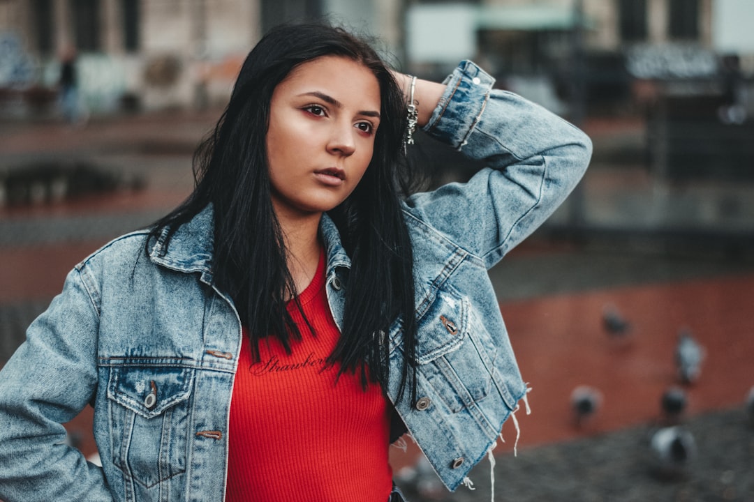 woman in red shirt and blue denim jacket