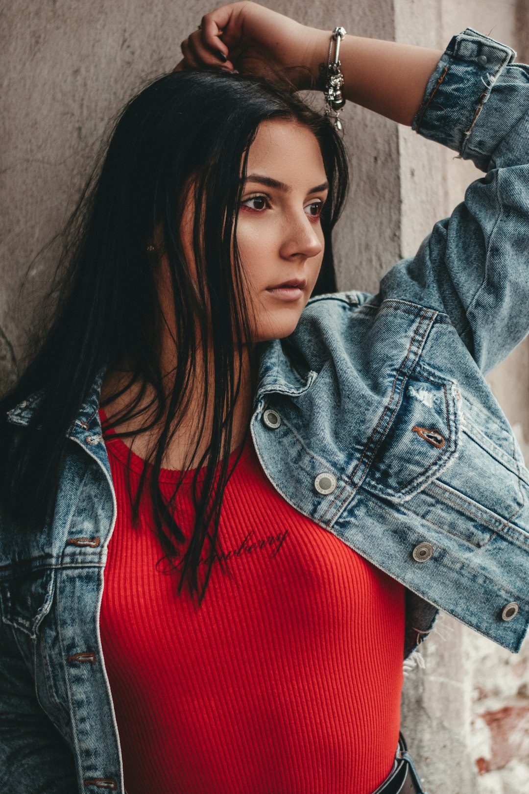 woman in red shirt and blue denim jacket