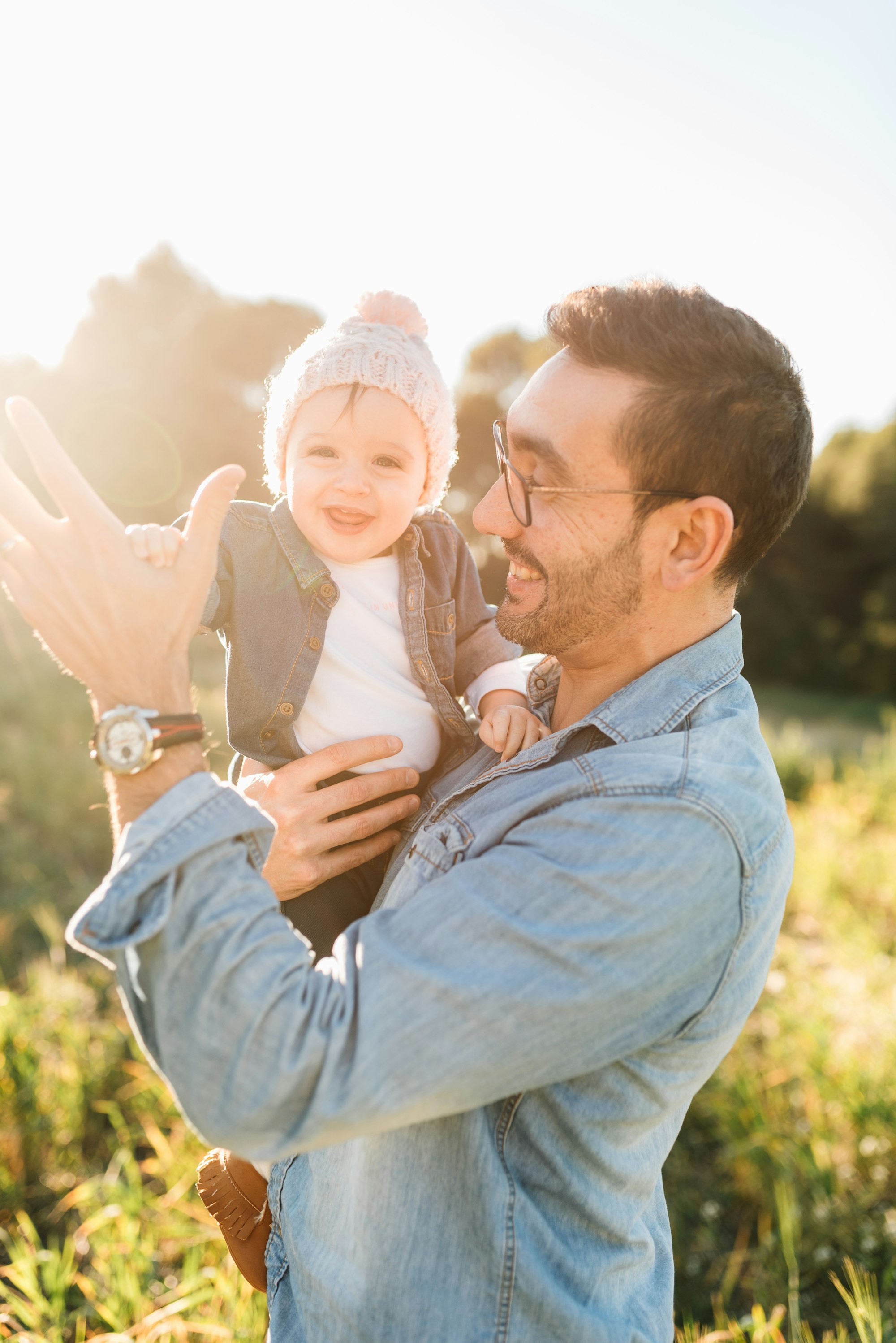 Father and his little daughter at sunset