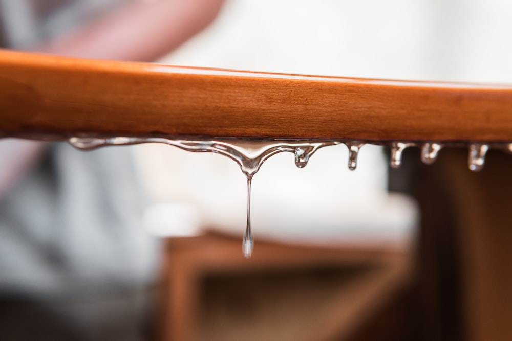 brown wooden handle bar with water droplets