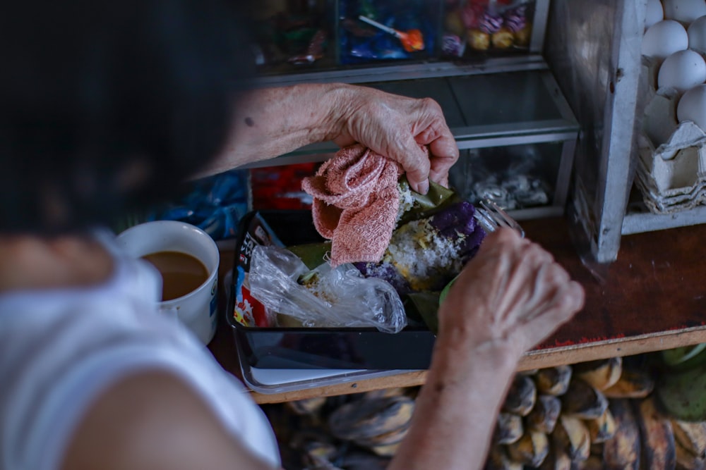 person holding bread with meat