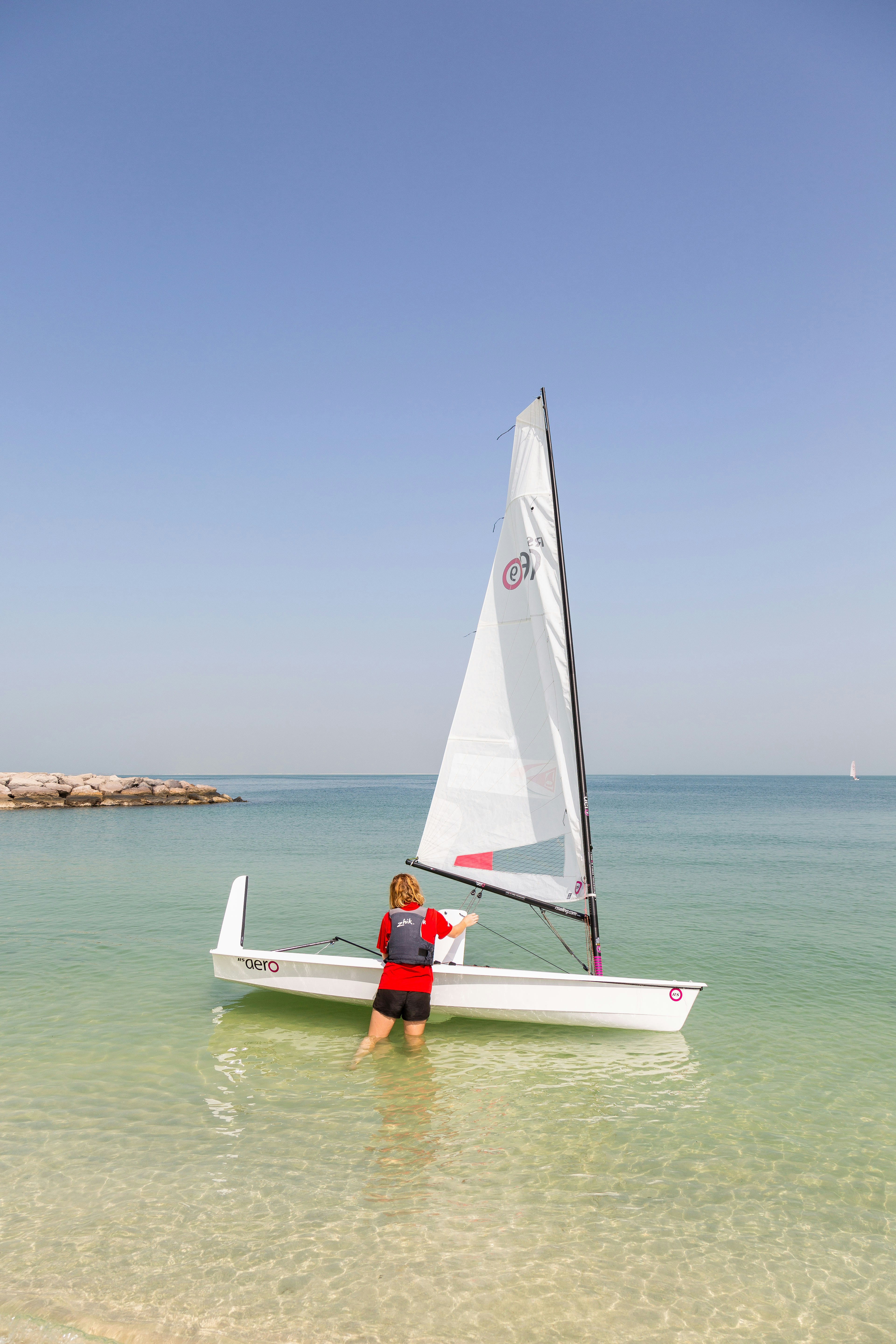 white sail boat on sea during daytime