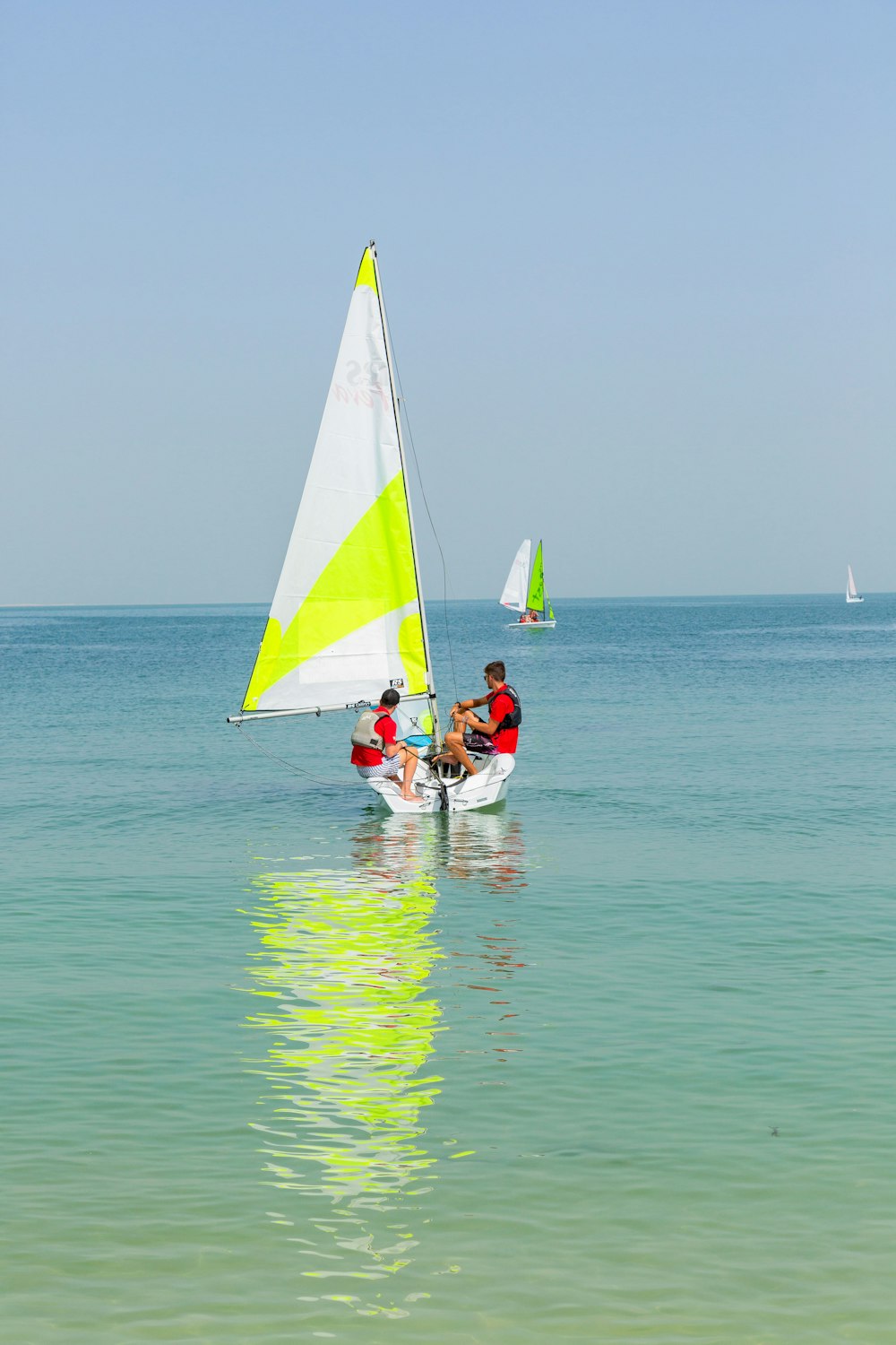 2 people riding on boat on sea during daytime