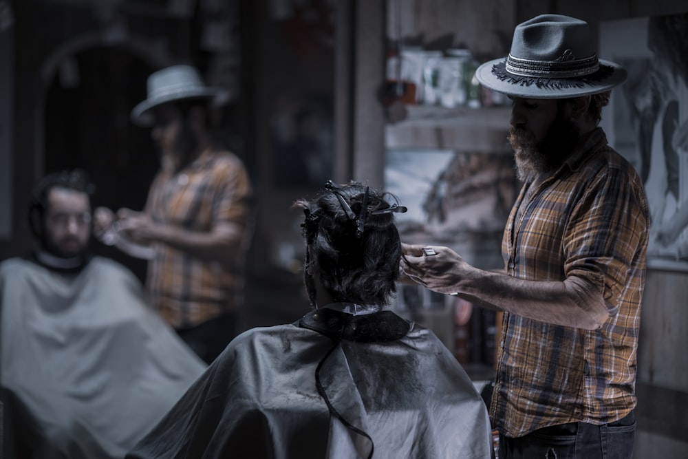 man in black hat and plaid shirt