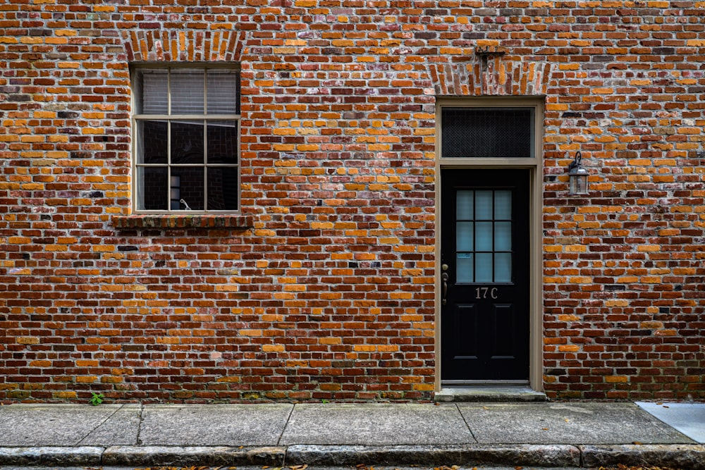 brown brick building with black wooden door