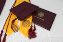 black academic hat on yellow textile