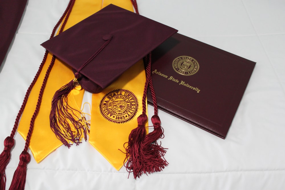 black academic hat on yellow textile