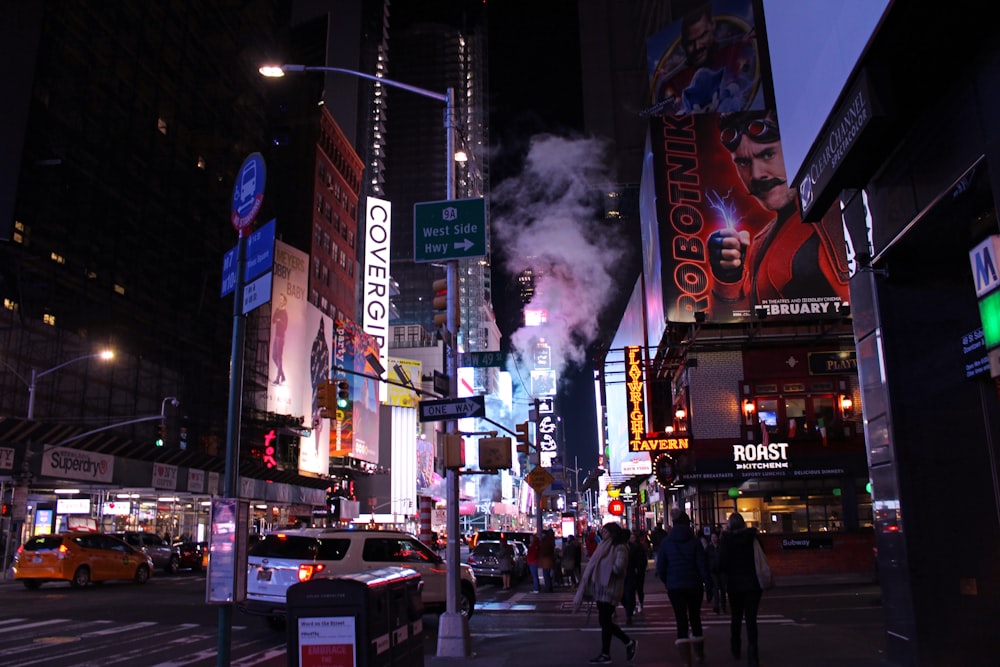 people walking on street during night time