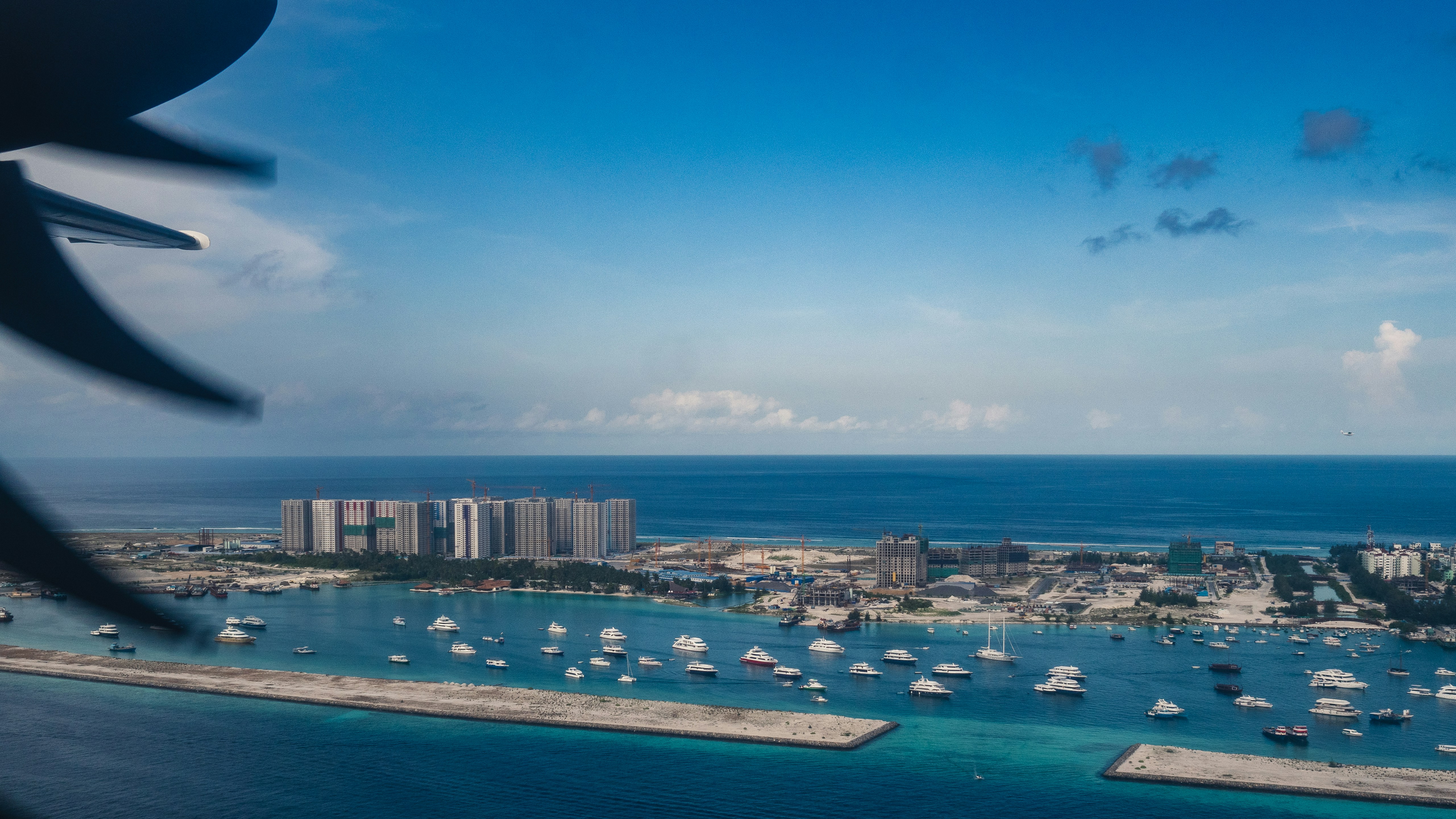 aerial view of city buildings near body of water during daytime