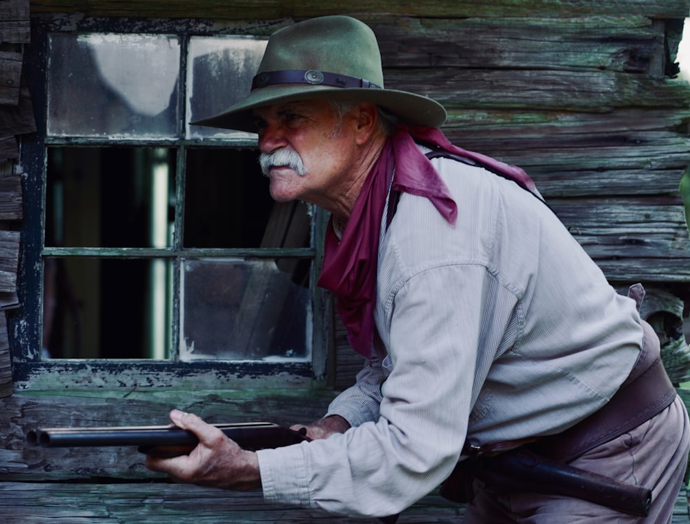 man in brown cowboy hat and gray dress shirt