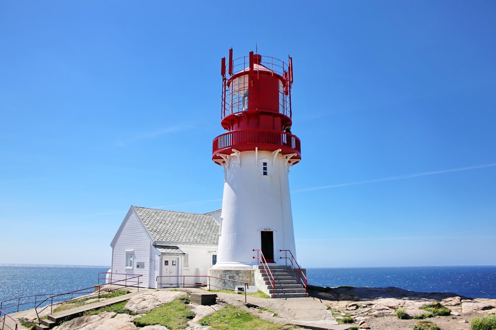 white and red lighthouse under blue sky during daytime