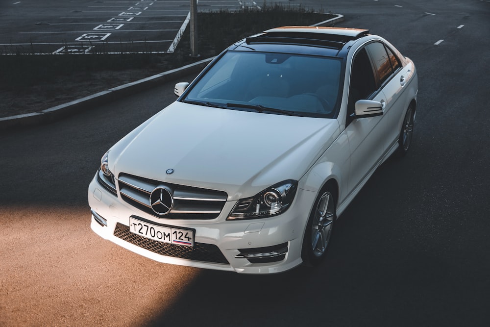 white mercedes benz coupe on road during daytime