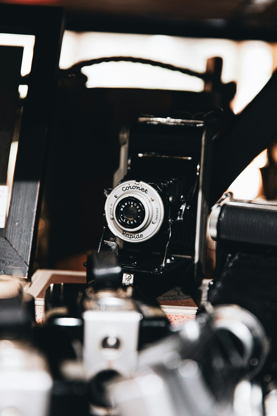 black and silver camera on brown wooden table