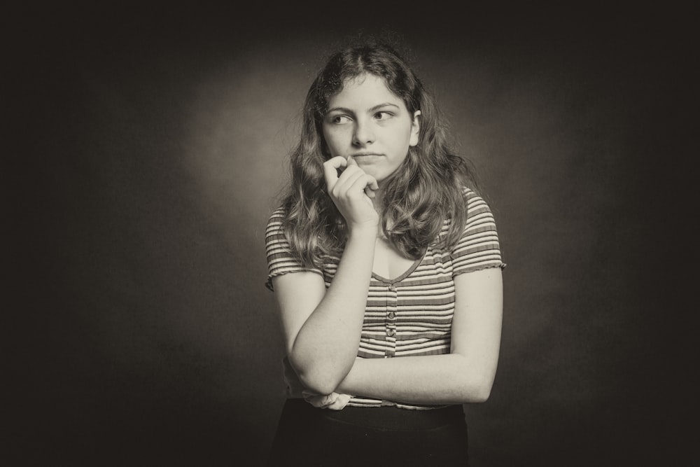 woman in stripe shirt covering her mouth with her hand