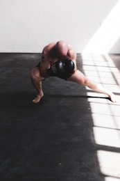 man in black boxing gloves doing push up