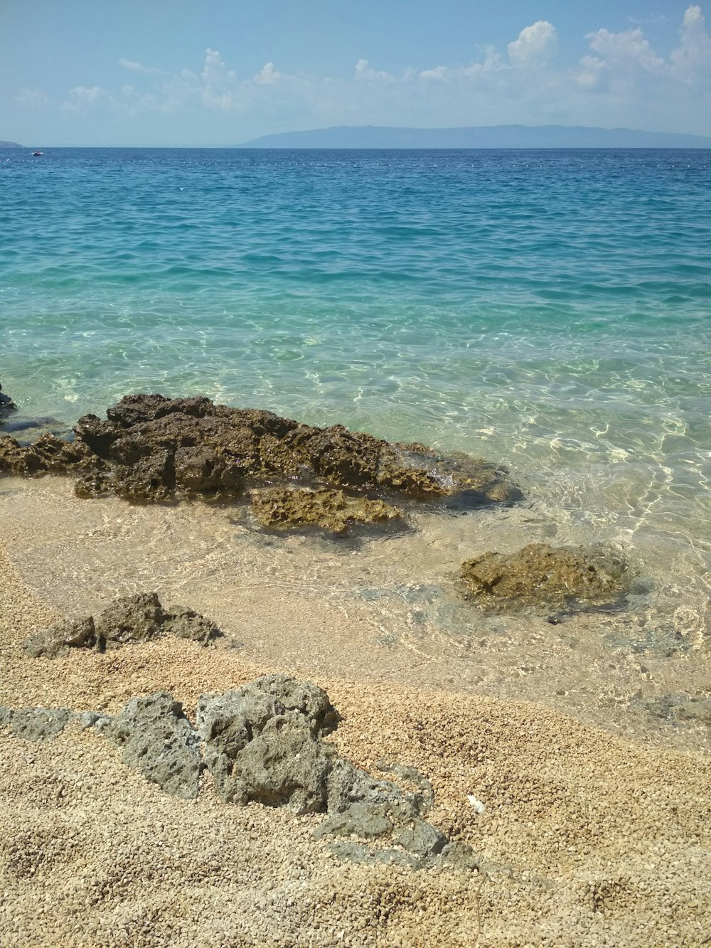 brown rocks on seashore during daytime