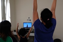 woman in blue t-shirt raising her hands