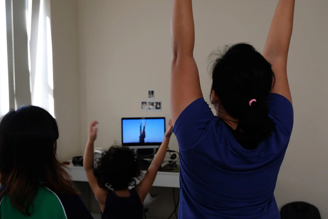 woman in blue t-shirt raising her hands
