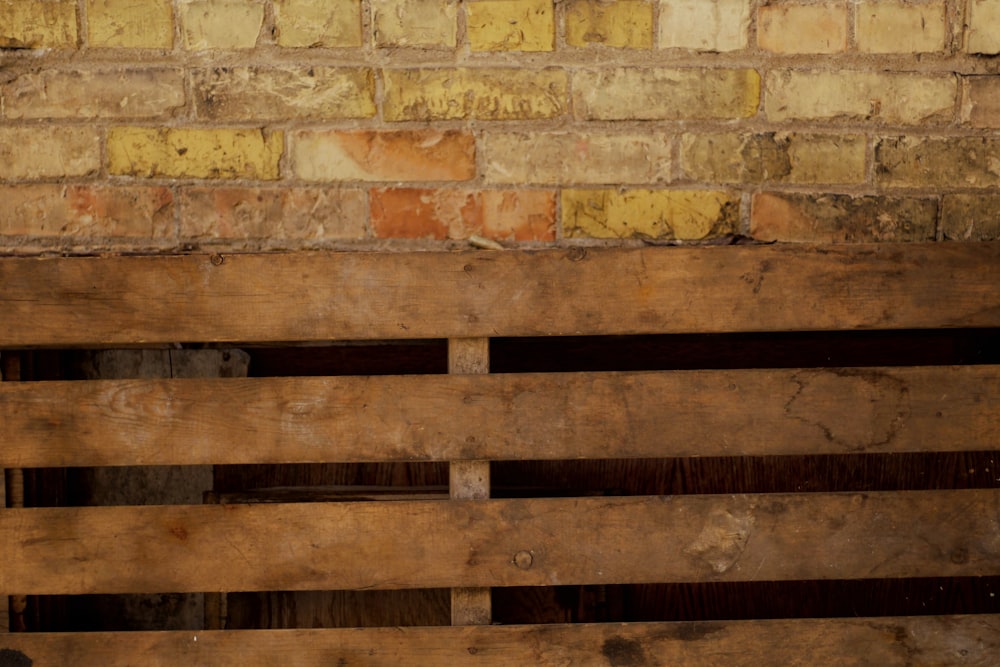 brown wooden door on brown brick wall