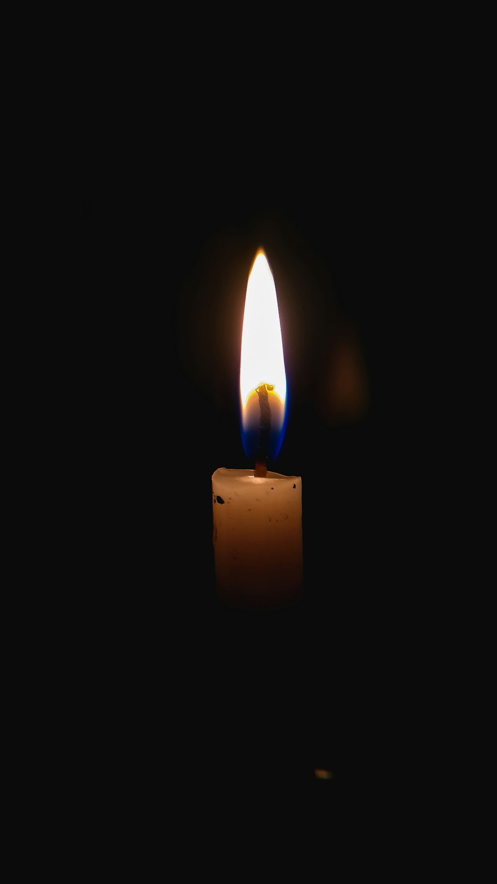 lighted candle in dark room