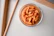 Close-up of a bowl filled with crispy makhana on a wooden table.