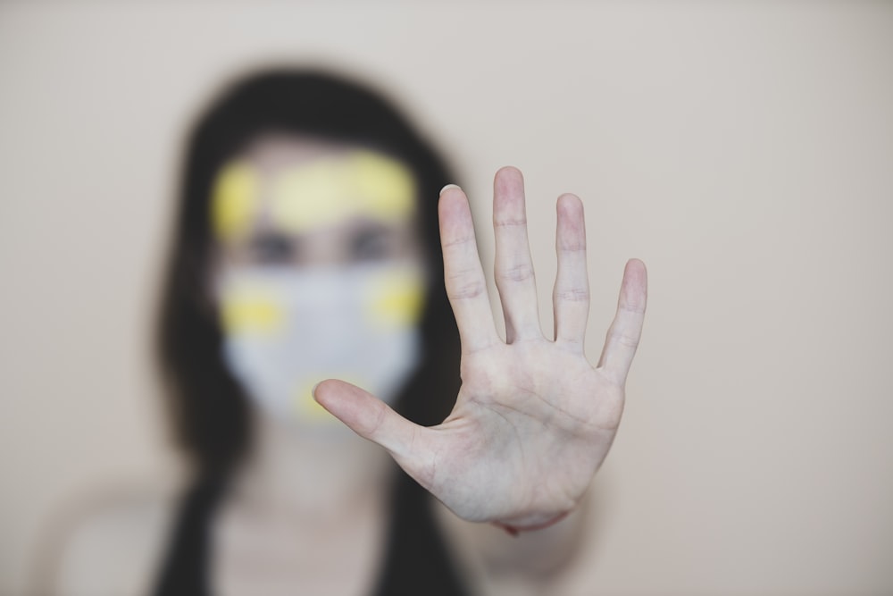 persons hand with yellow and black paint