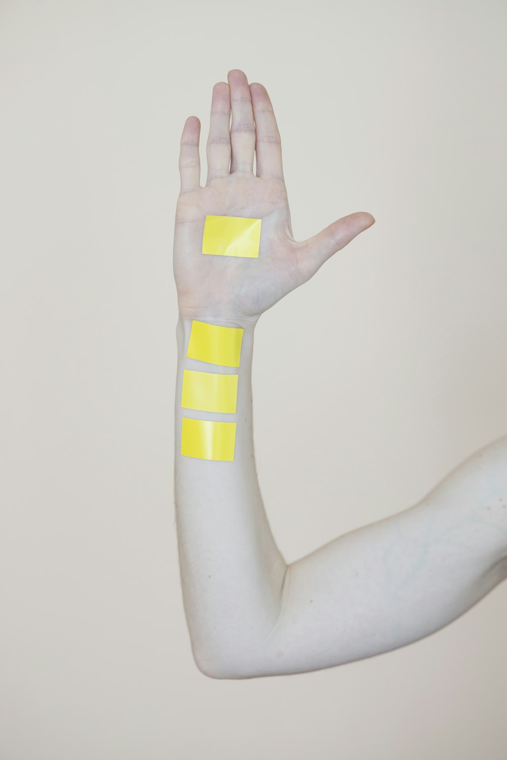 person holding yellow and white cross