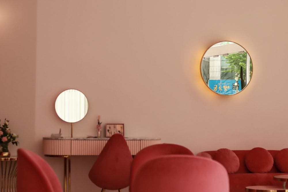 red sofa near round mirror