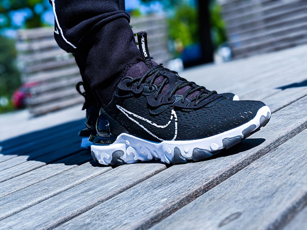 A Person Wearing Black and White Nike Sneakers · Free Stock Photo