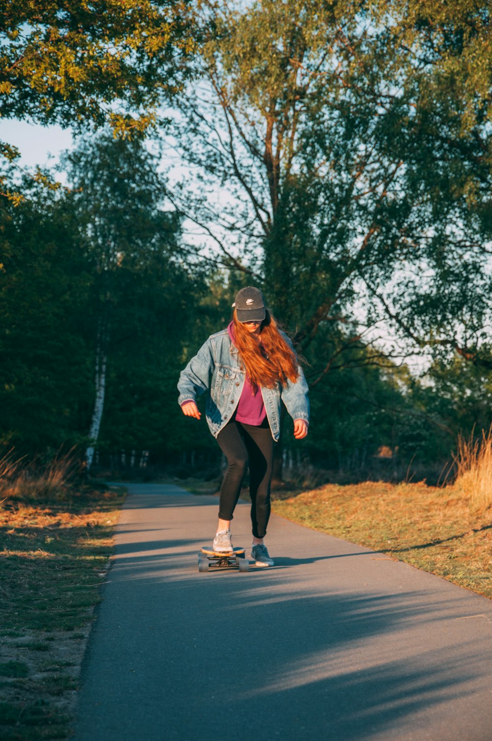 woman in white jacket and black pants running on road during daytime