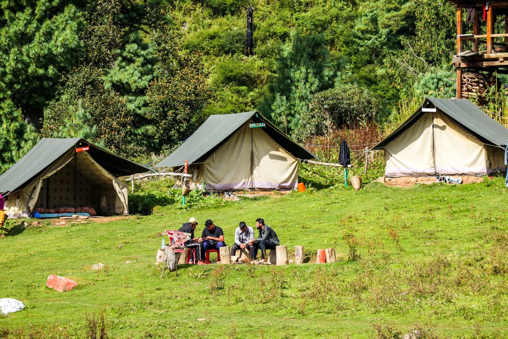 people sitting on camping chairs near tent during daytime