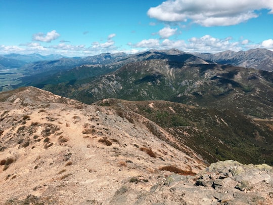 brown and green mountains under blue sky during daytime in Mount Isobel New Zealand