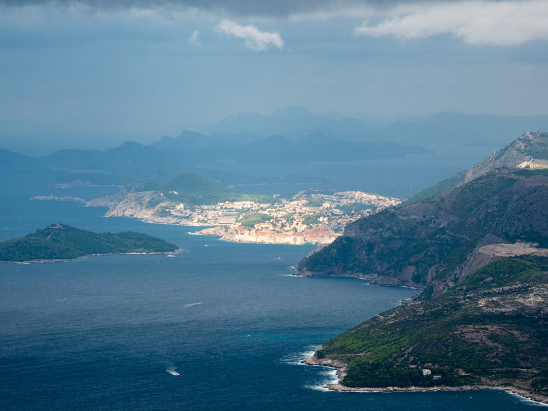 aerial view of green mountains and body of water during daytime