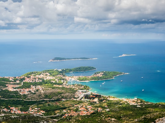 green grass covered island during daytime in Cavtat Croatia