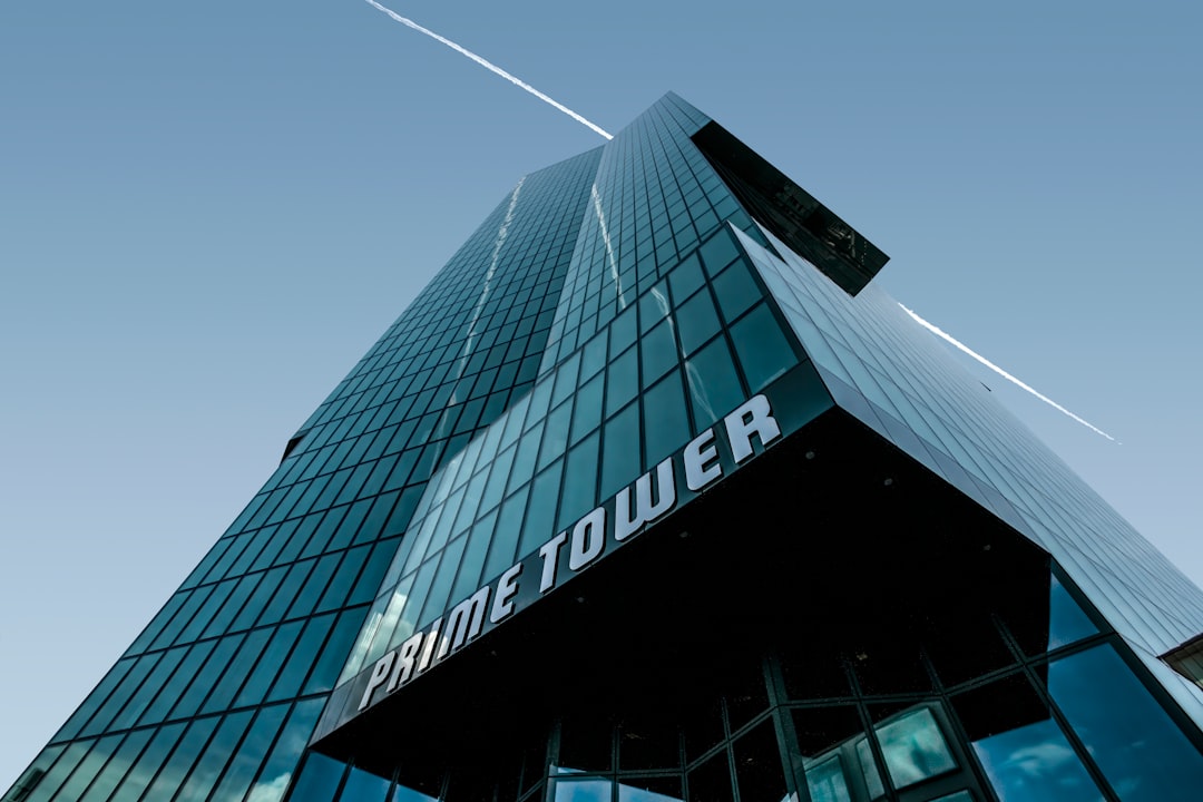 low angle photography of glass walled building under blue sky during daytime